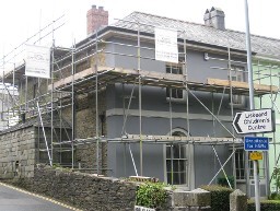 Erected scaffolding around a small building